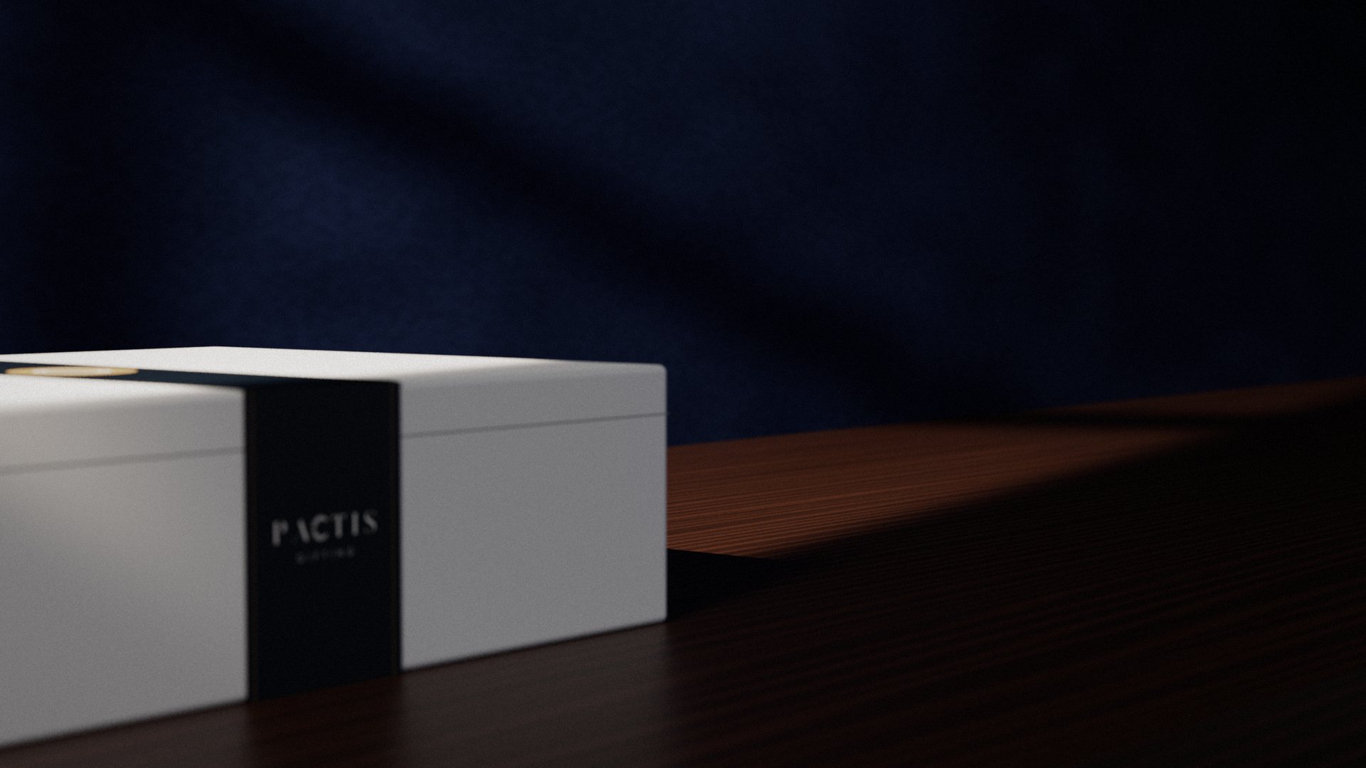 A white Pactis gift box seen low on a walnut sideboard, the navy belly band carrying the Pactis wordmark