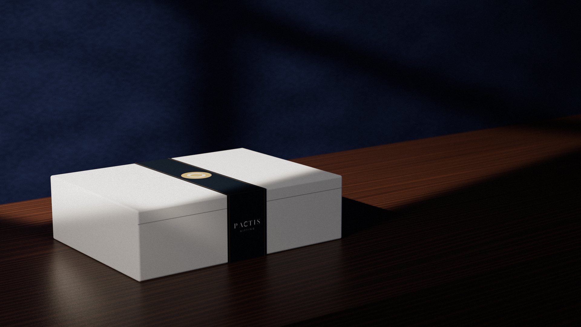 A white Pactis gift box wrapped in a navy belly band with the brass Pactis seal on the lid and the Pactis wordmark on the front, on a walnut sideboard in warm window light